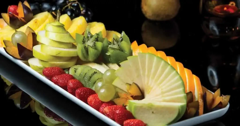 Assembling green fruit platter